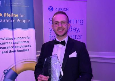 A photo of George Richardson with the Cii Young achiever of the year award