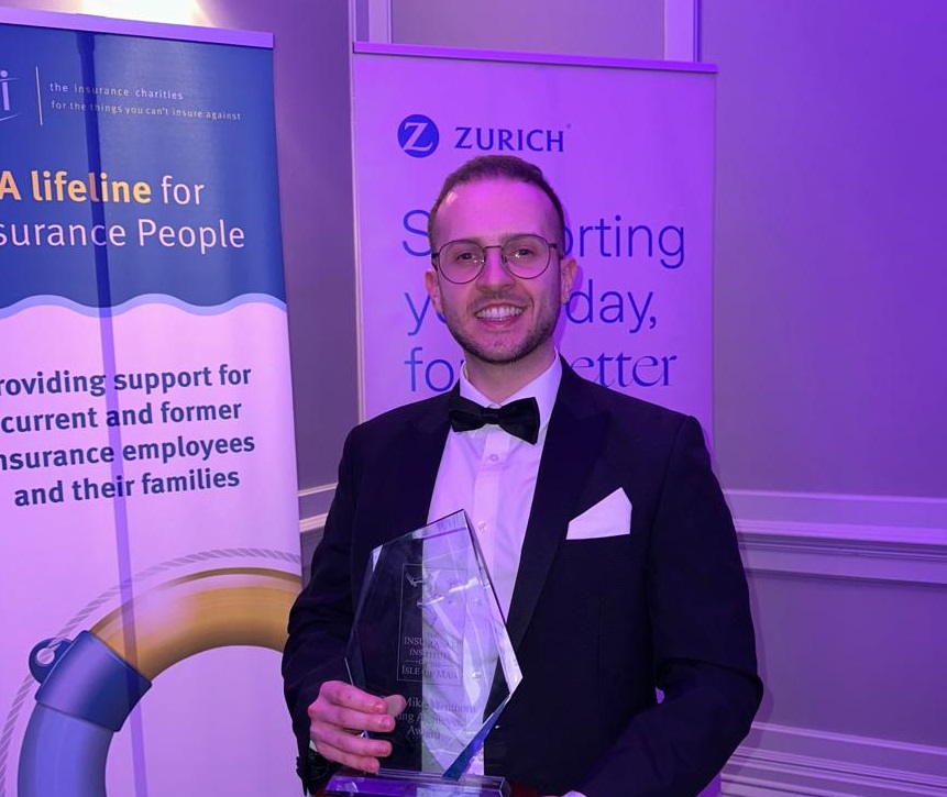 A photo of George Richardson with the Cii Young achiever of the year award