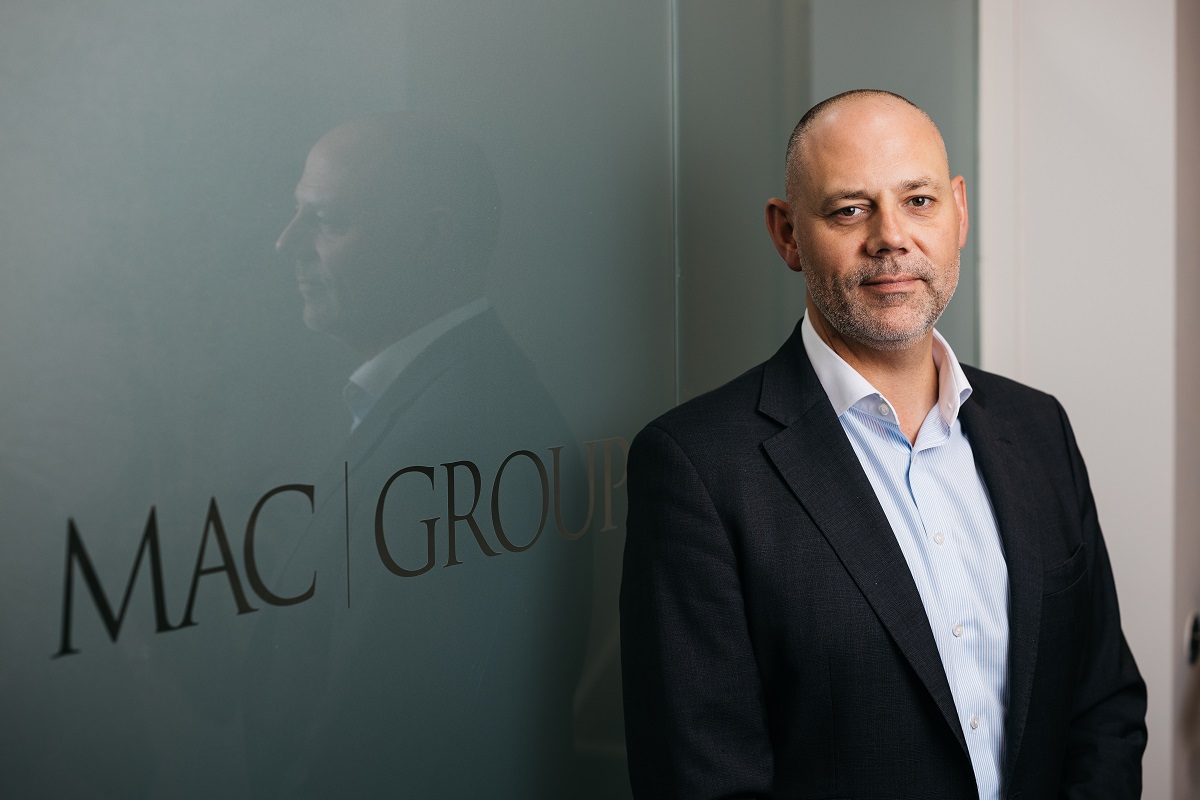 A portrait of Ed Walter by the MAC Logo