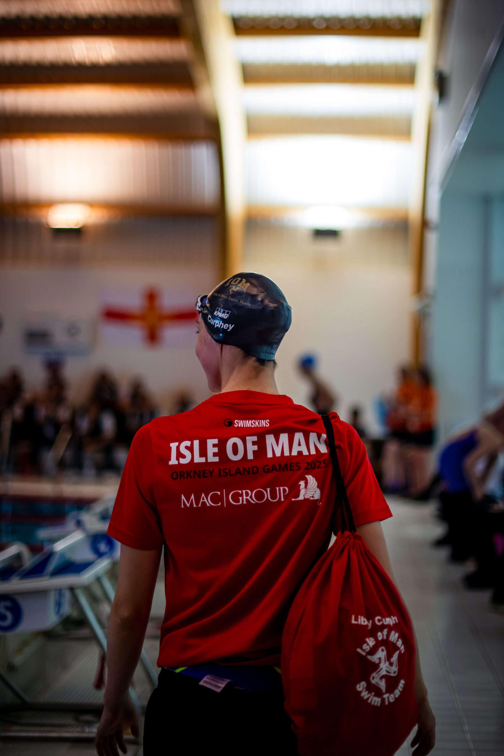 A photo of the branding on the back of IOM Swim team kits