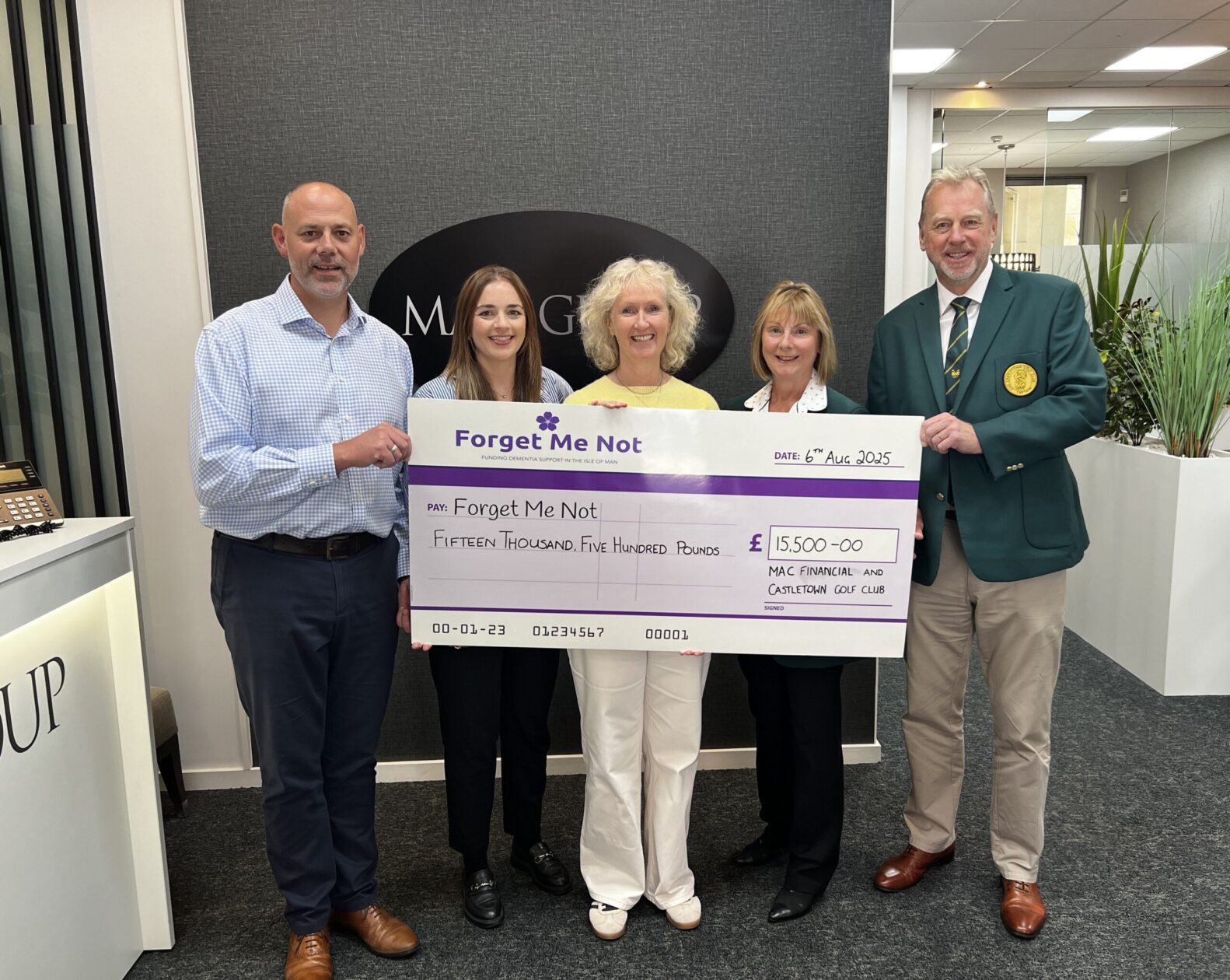 A cheque presentation photo following the MAC Golf Day. Pictured are Ed and Hannah from MAC alongside Gemma from the Charity Forget Me Not and Belinda and Rich from Castletown