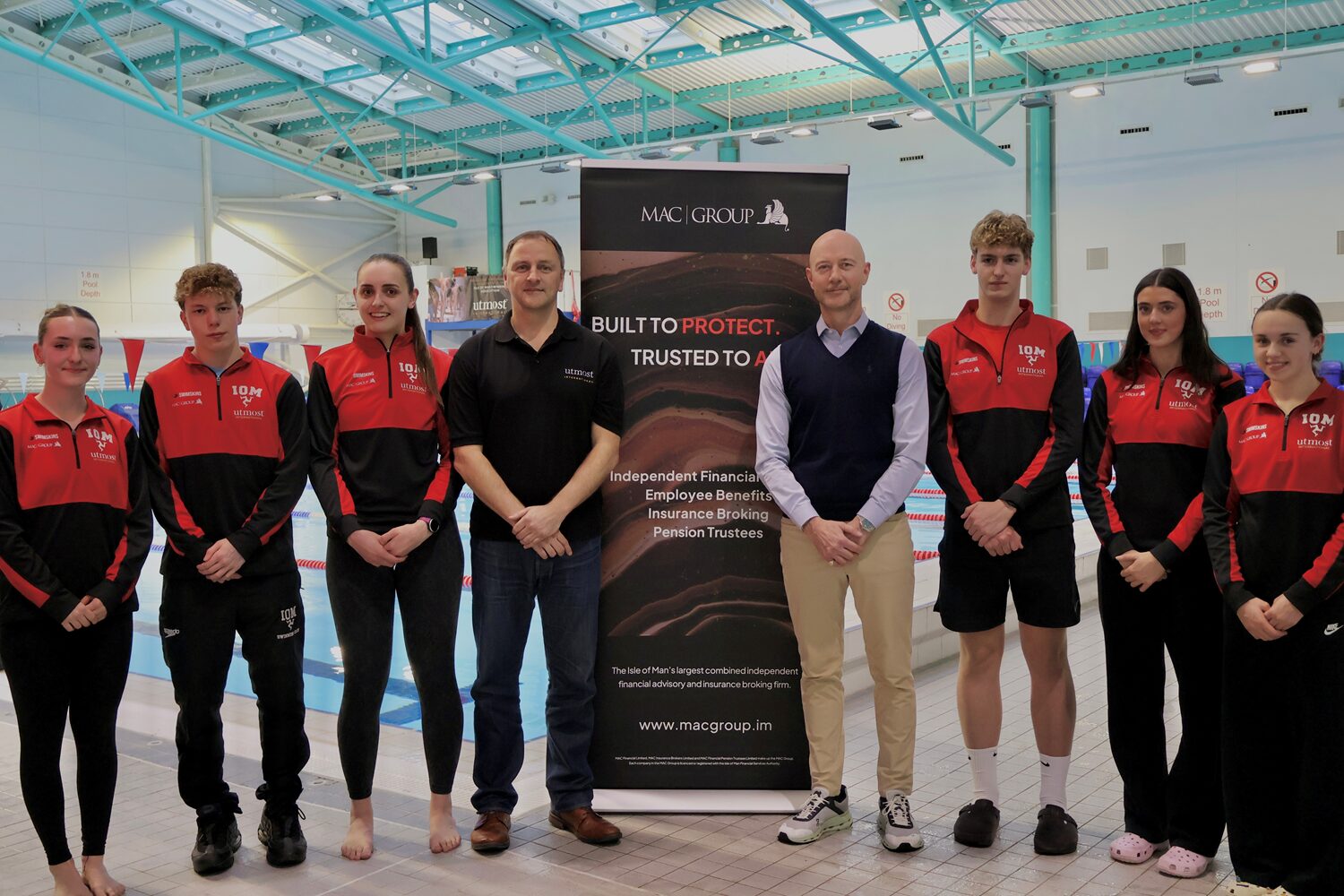 A photo of representatives from IOM Swim Team alongside principle sponsors Utmost and MAC Group